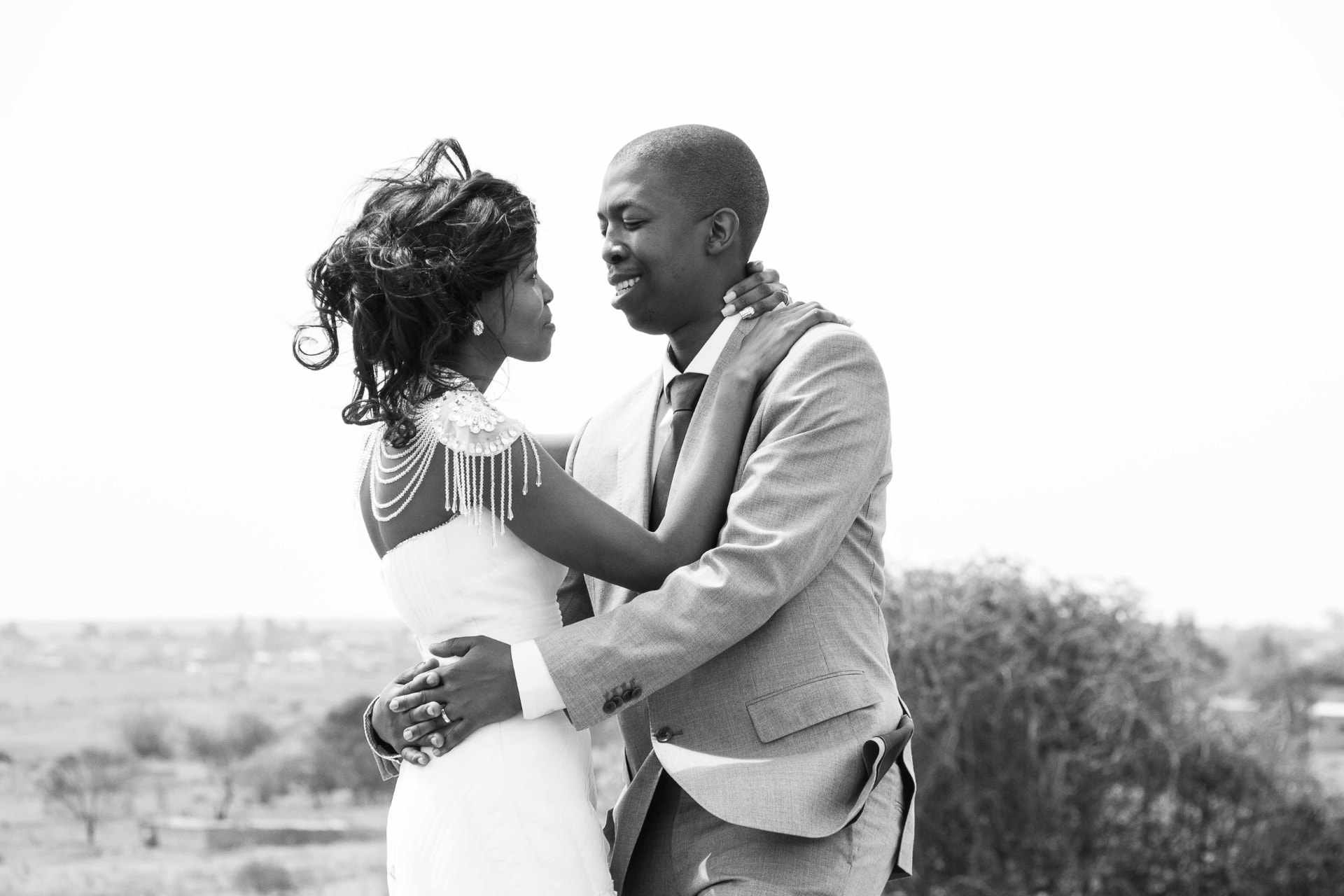 Black and white wedding portrait of a couple embracing