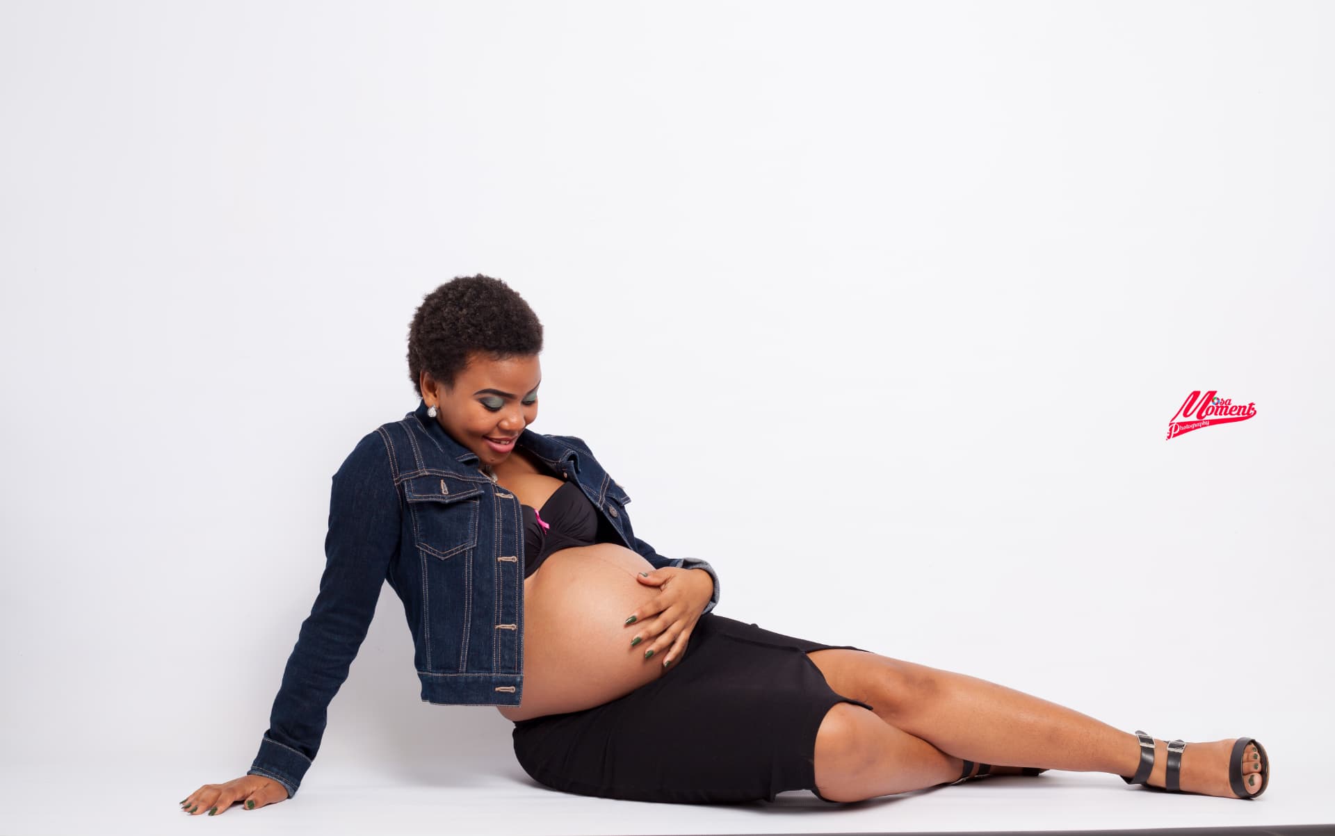 Clean white-background studio maternity portrait